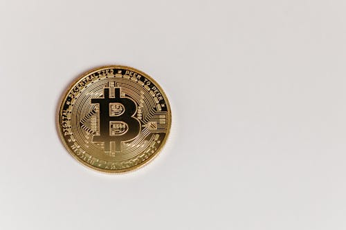 Gold Bitcoin on White Surface