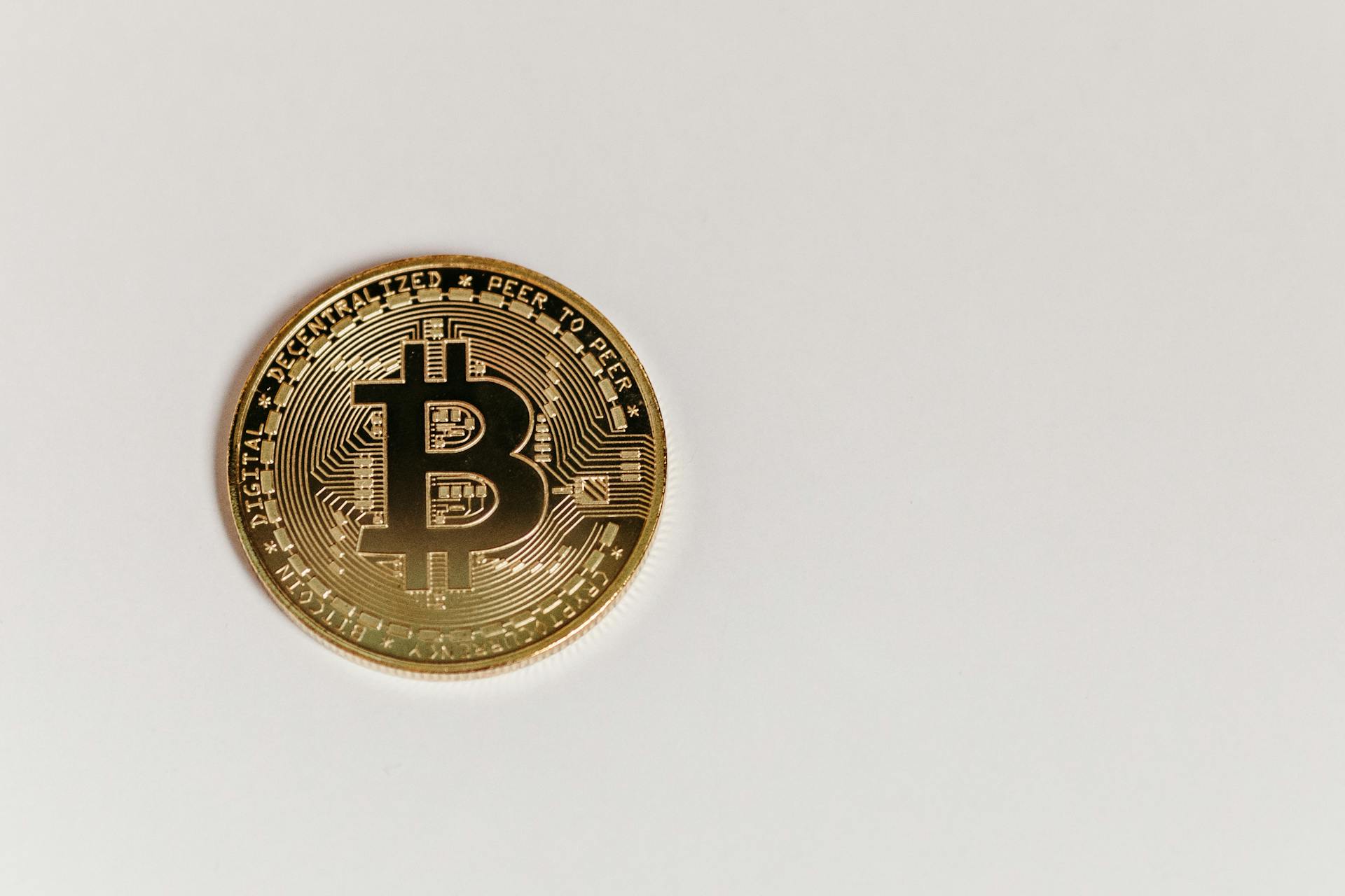 Gold Bitcoin on White Surface