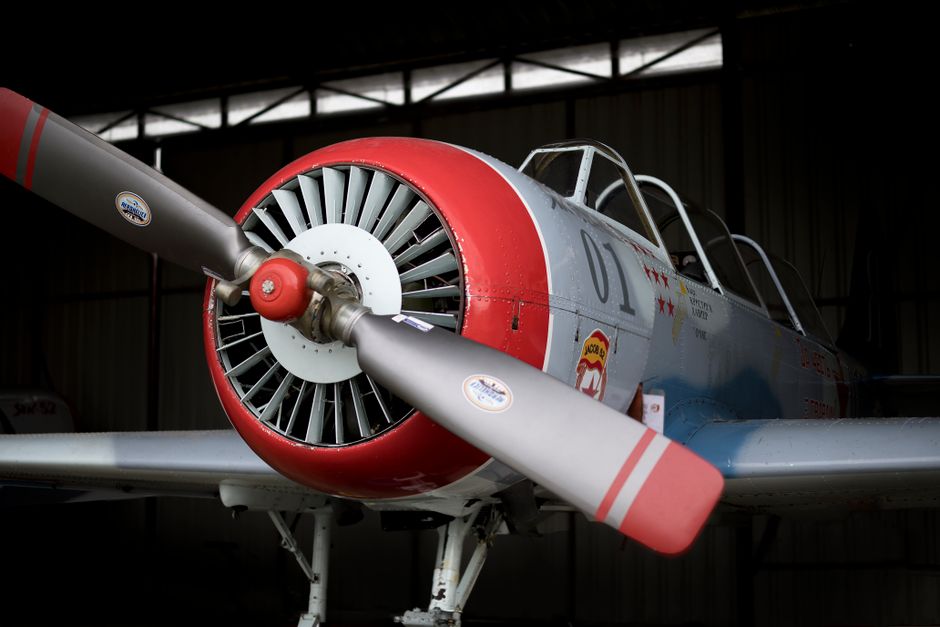 Vintage aircraft parked indoors showcasing aviation engineering.