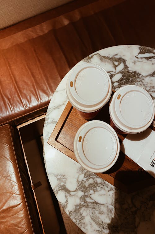 Paper Cups of Hot Coffee on a Wooden Tray