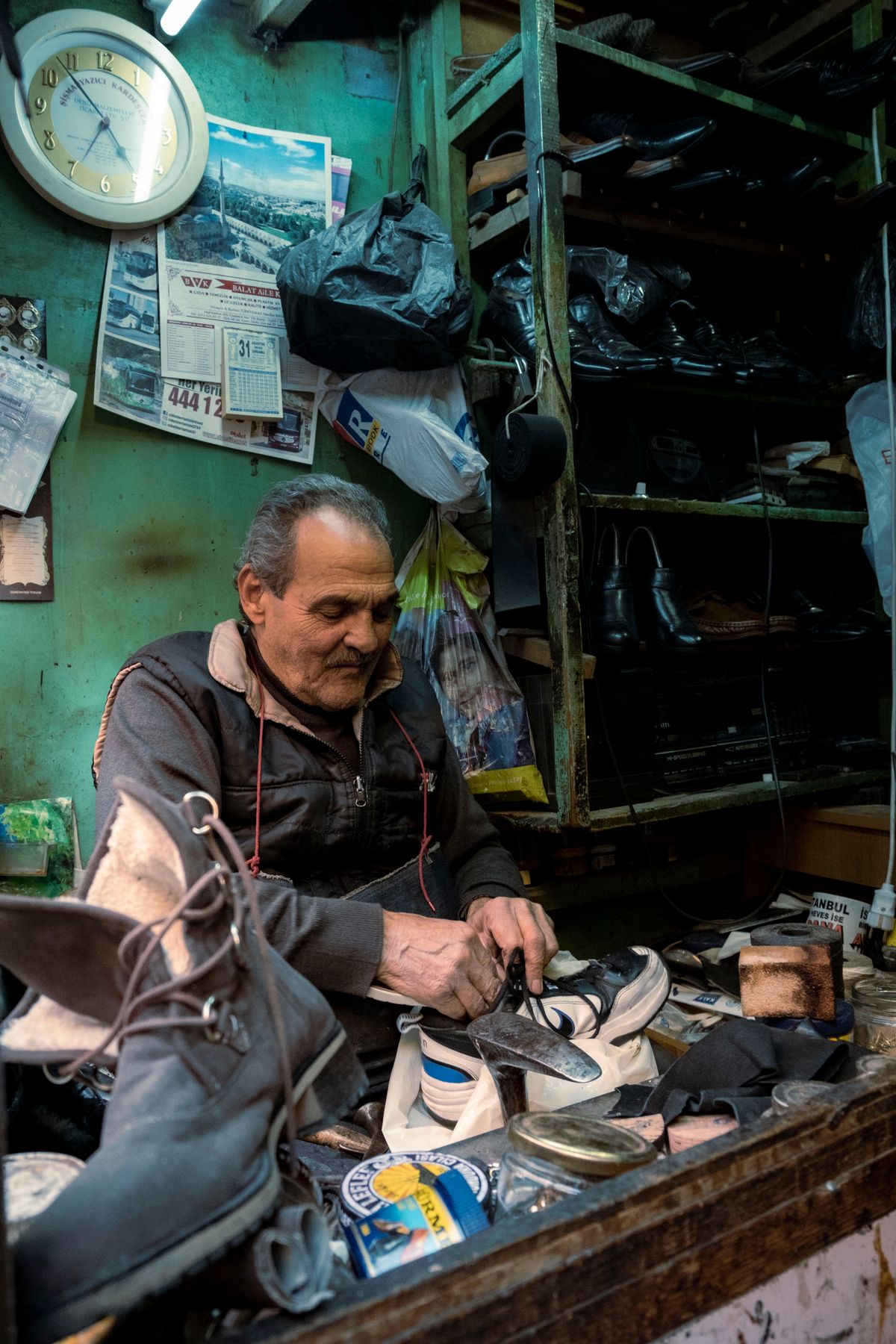 Cobbler hand-stitching a leather shoe sole in a repair workshop