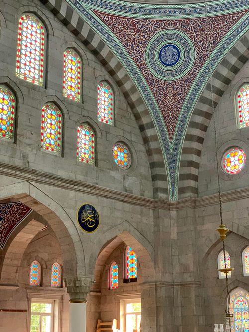Free Intricate mosque interior featuring colorful stained glass windows and detailed arches. Stock Photo