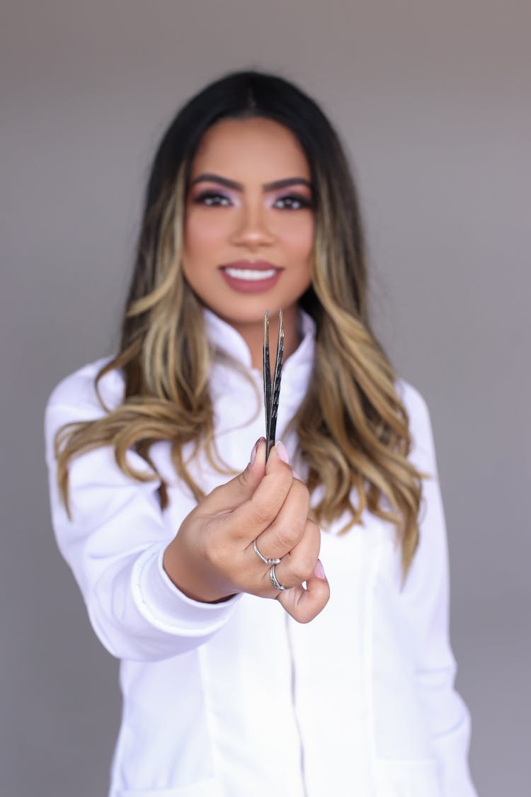 Photo Of A Woman Holding Tweezers