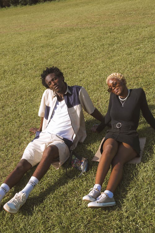 Woman and Man Sitting on Grass