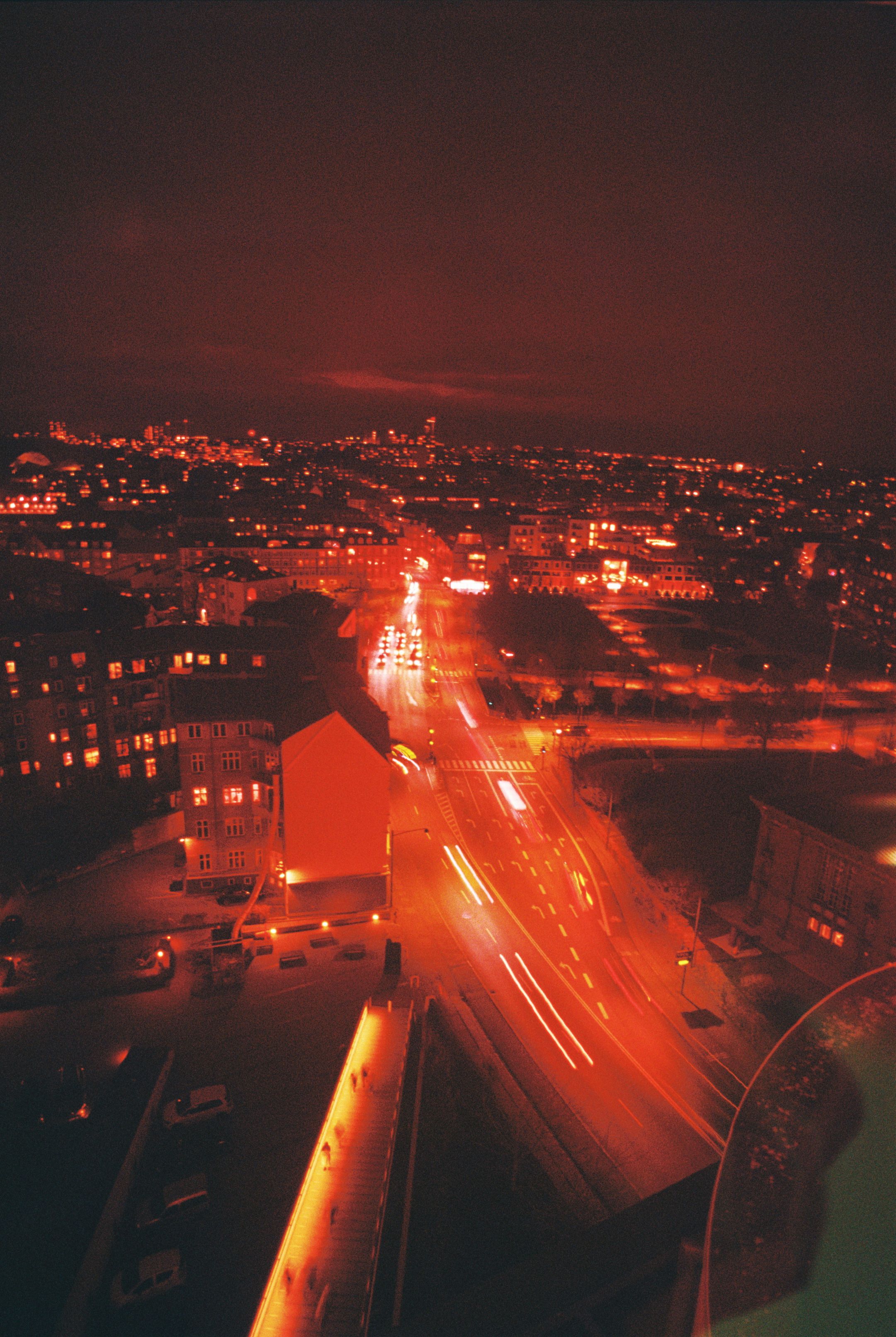 Stunning aerial view of Aarhus at night with illuminated streets and city skyline.