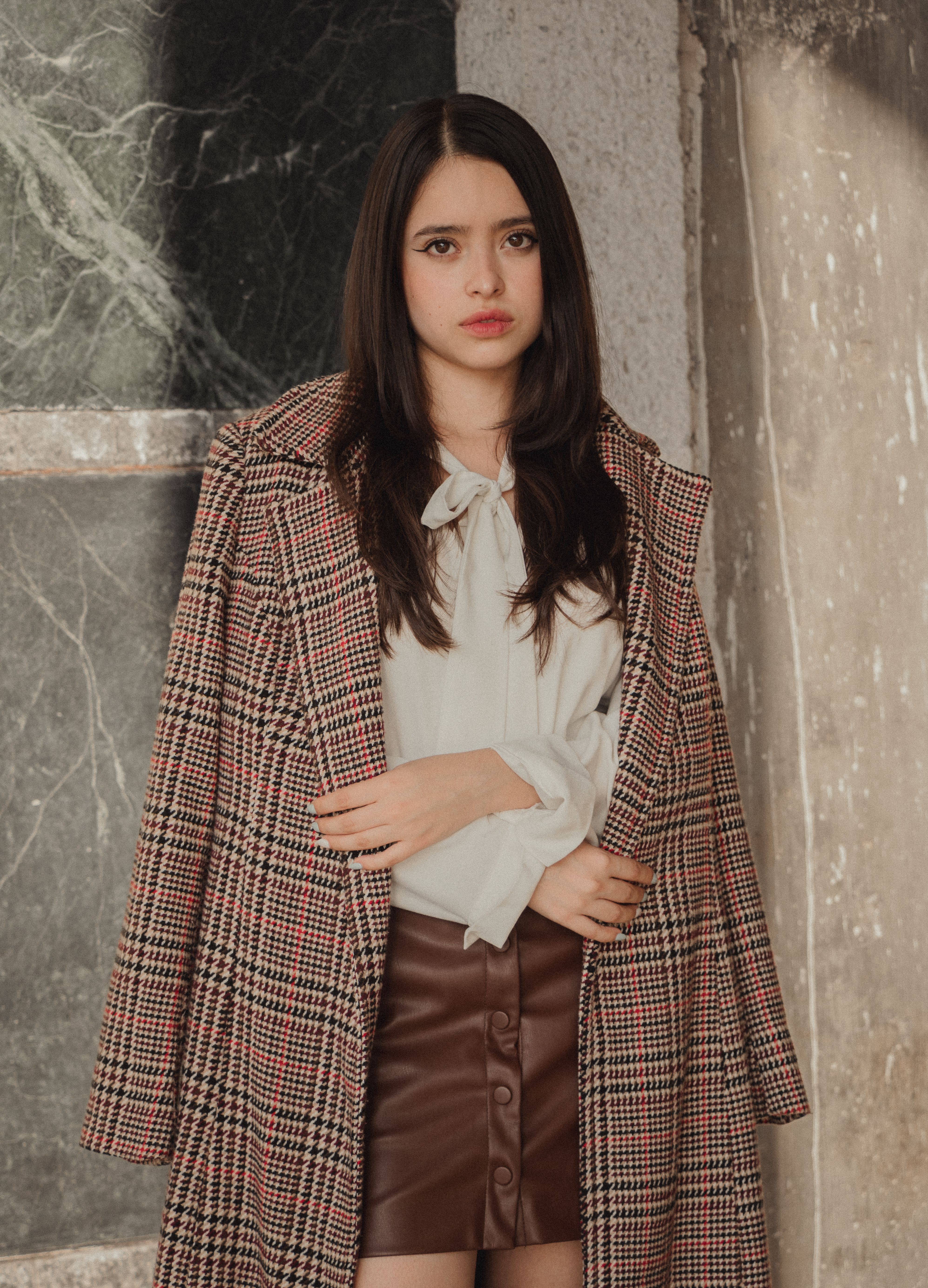 Woman in gray plaid wool coat with black turtleneck dress