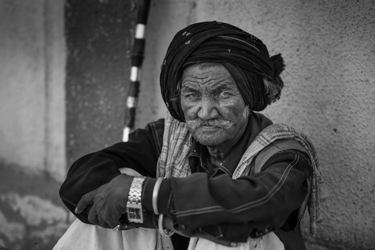 Elderly Man Sitting On City Street