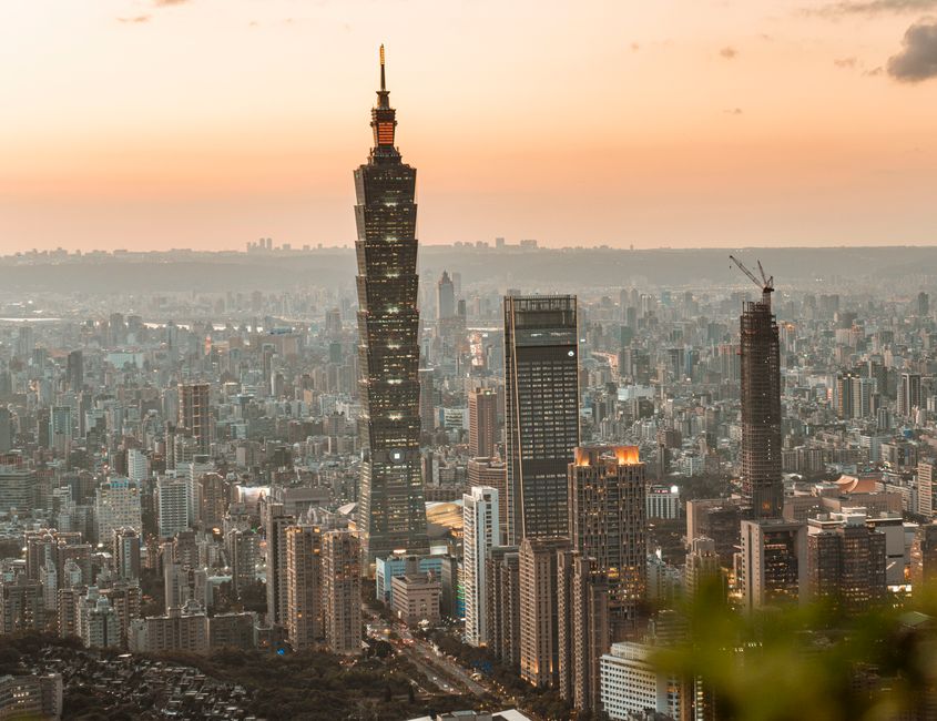 Breathtaking view of Taipei 101 amid the cityscape at sunset, showcasing Taiwan's vibrant skyline.