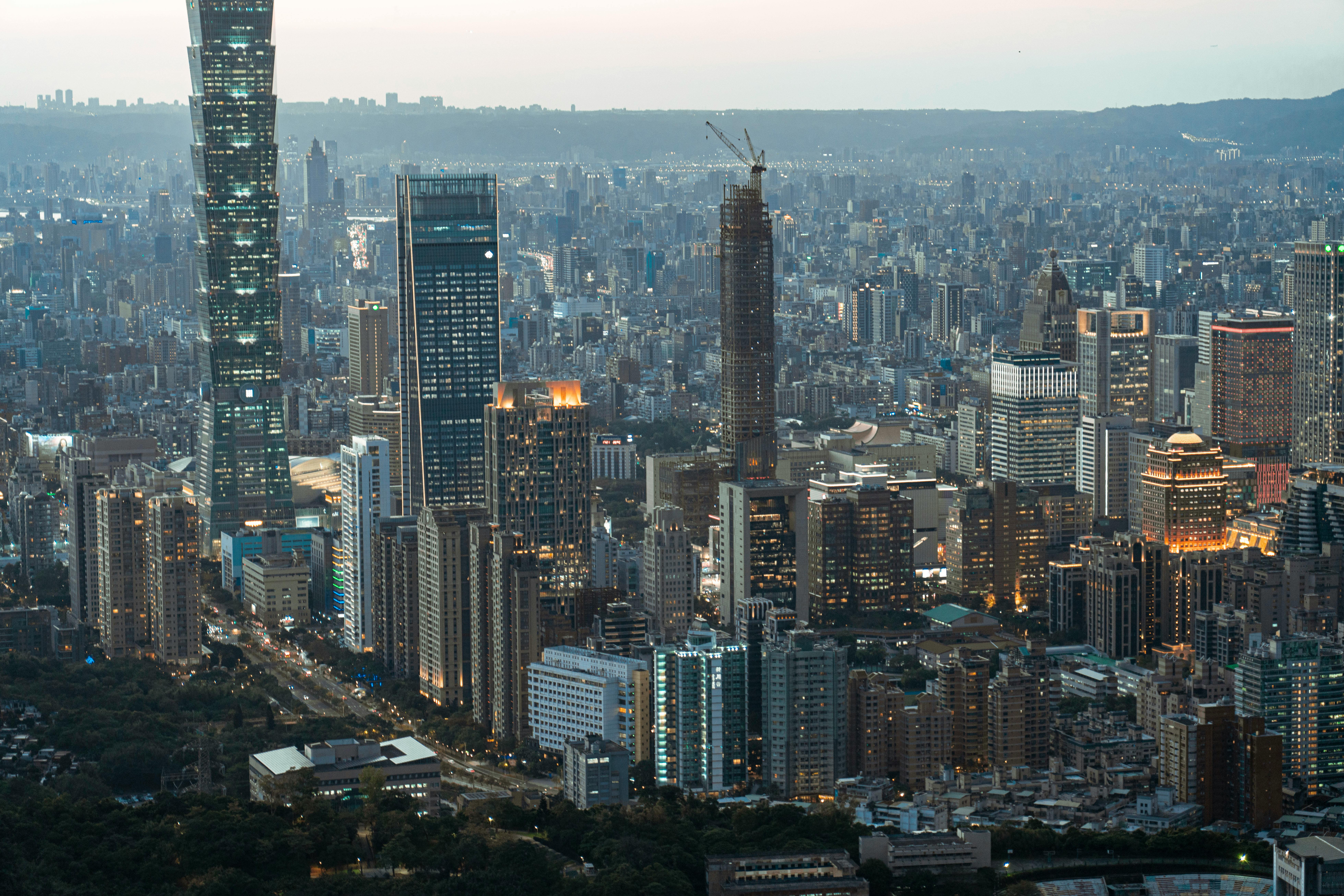 Aerial view of Taipei city skyline featuring Taipei 101 during twilight.
