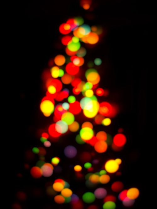 Free Colorful circular bokeh lights create a festive abstract pattern against a dark background. Stock Photo
