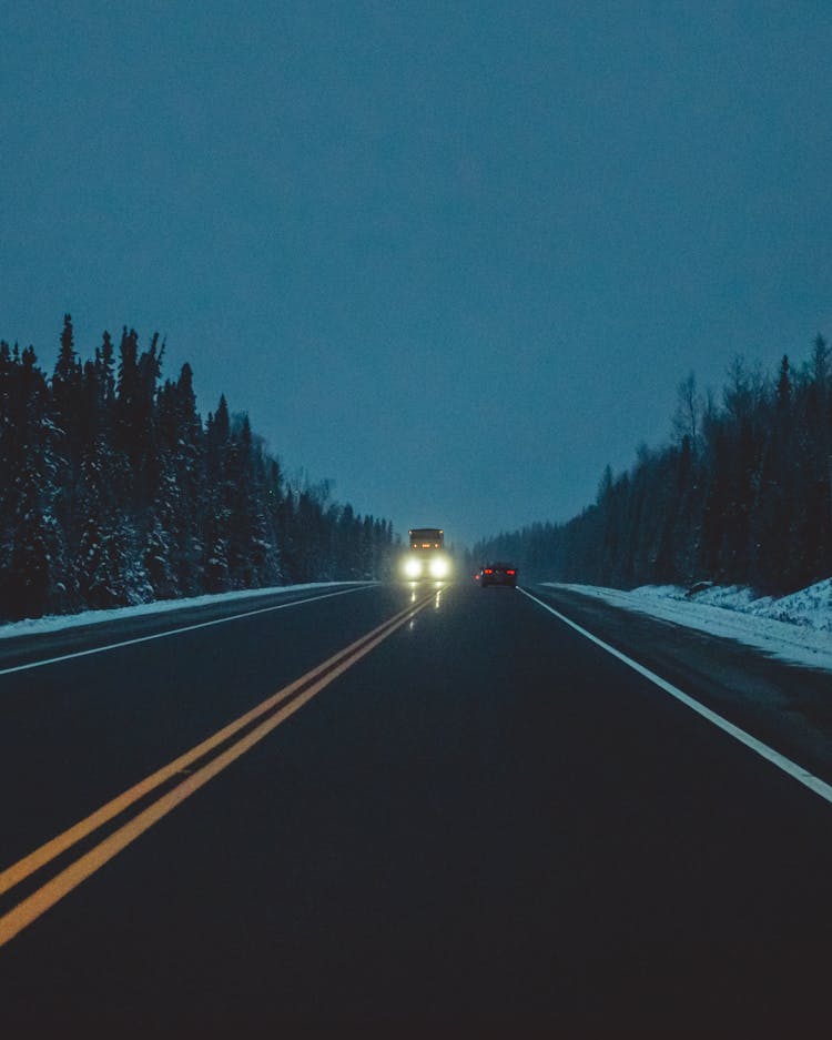 Car In A Road With Headlights Turn On