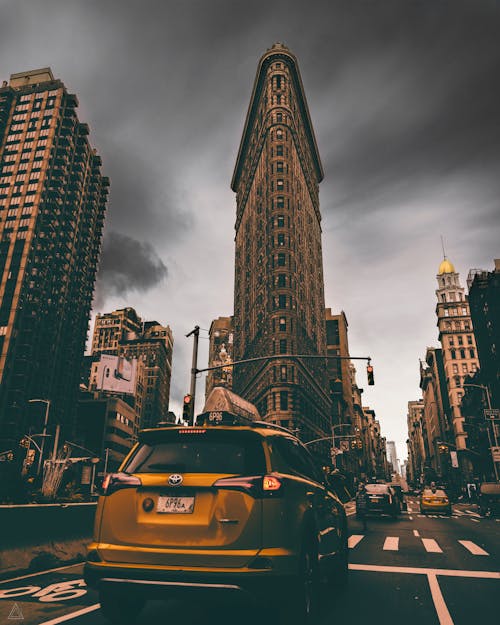 Free Yellow Toyota Rav4 Suv Running on Road Near Flatiron Building, New York Stock Photo