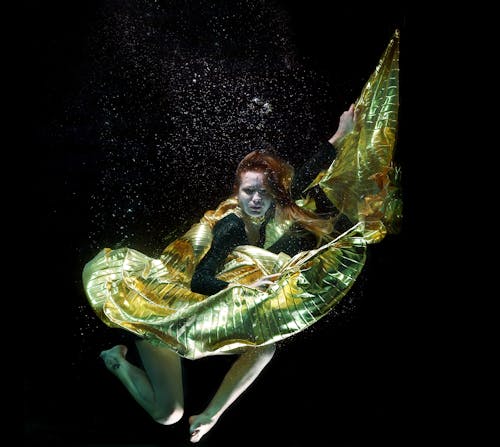 Underwater Photo of Woman Wearing Green and Black Dress