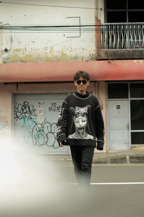 Man Wearing Sunglasses and Black Sweater Crossing the Street