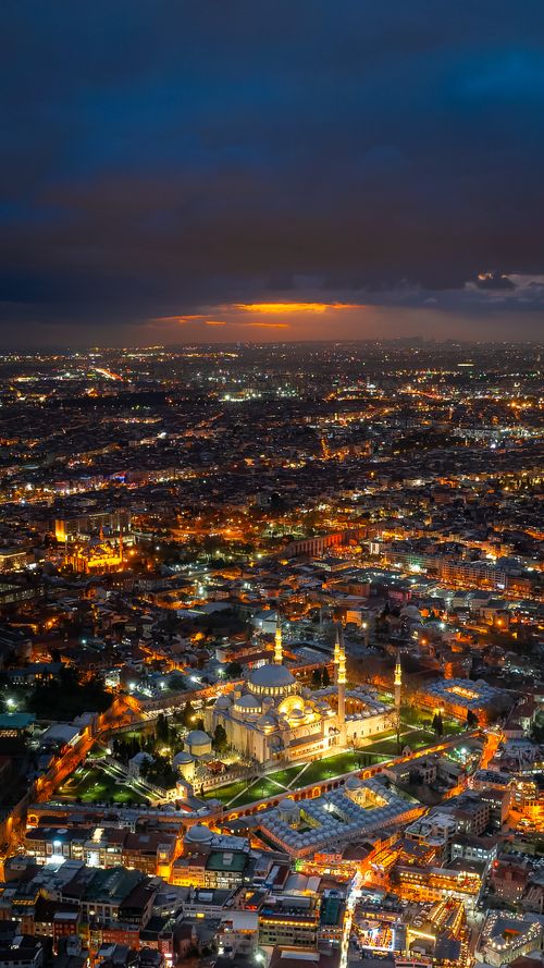 Free A stunning aerial shot of Istanbul's illuminated cityscape, showcasing vibrant city lights under a dramatic night sky. Stock Photo