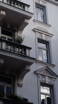 A detailed view of a classical residential building with multiple balconies and ornate design.