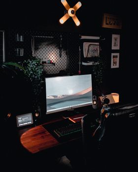 A modern home office setup with a computer monitor and ambient lighting.