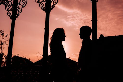 Silhouette of Man and Woman during Dawn