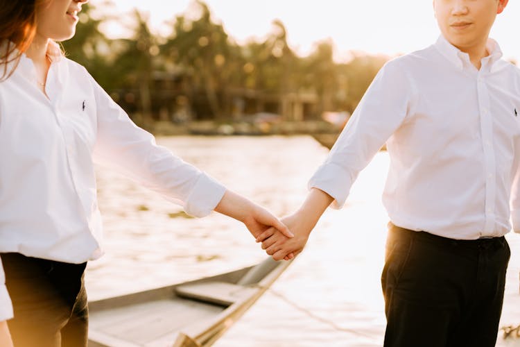 Couple In Shirts Holding Hands