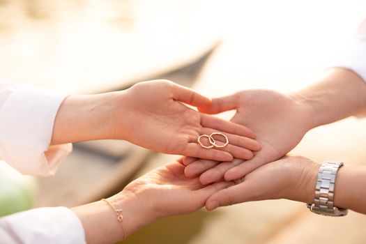 Man and Woman Holding Joined Rings