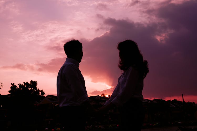 Silhouette Of A Couple Looking To The Sky 