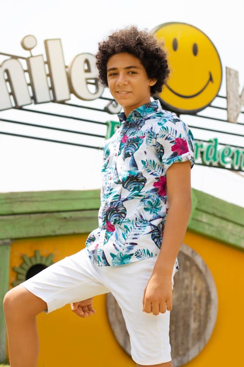Teenage Boy Posing in Floral Polo Short Sleeved and White Shorts