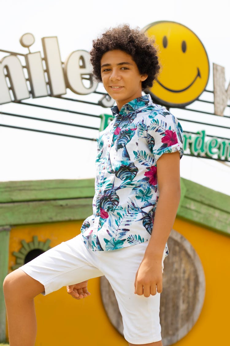 Teenage Boy Posing In Floral Polo Short Sleeved And White Shorts