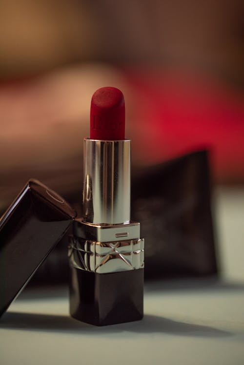 Close-Up Shot of a Red Lipstick on White Surface