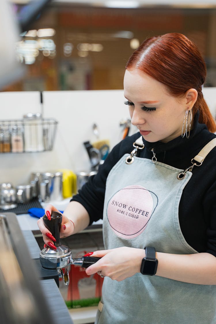 Woman Preparing Coffee On Cafe Kitchen