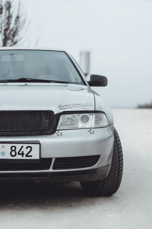 Free Close-up of a luxury car front, featuring sleek design and headlights. Stock Photo