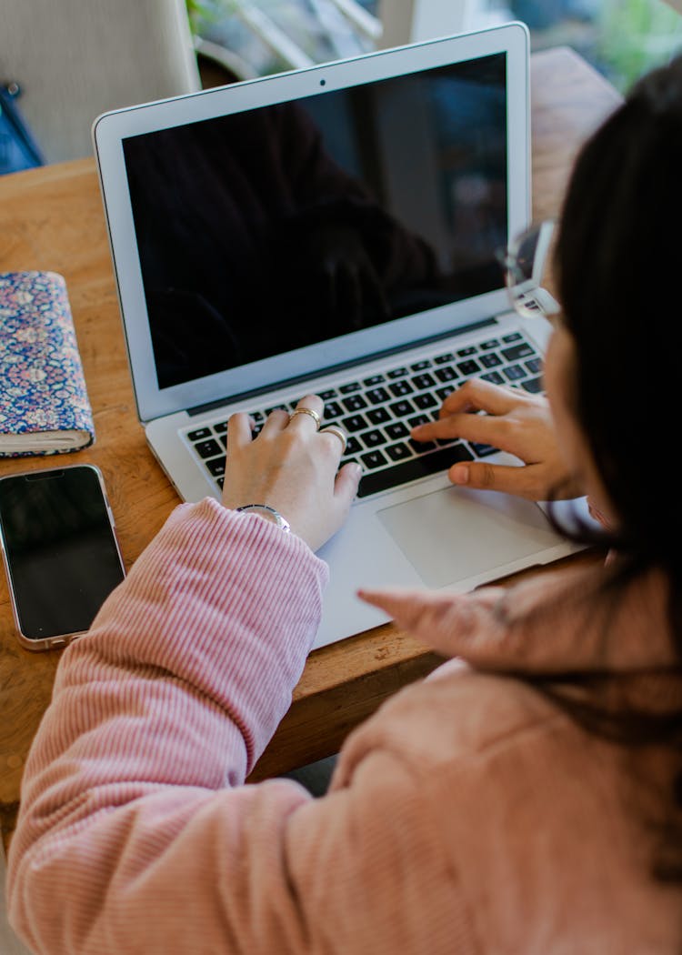 Woman Typing On Laptop Keyboard