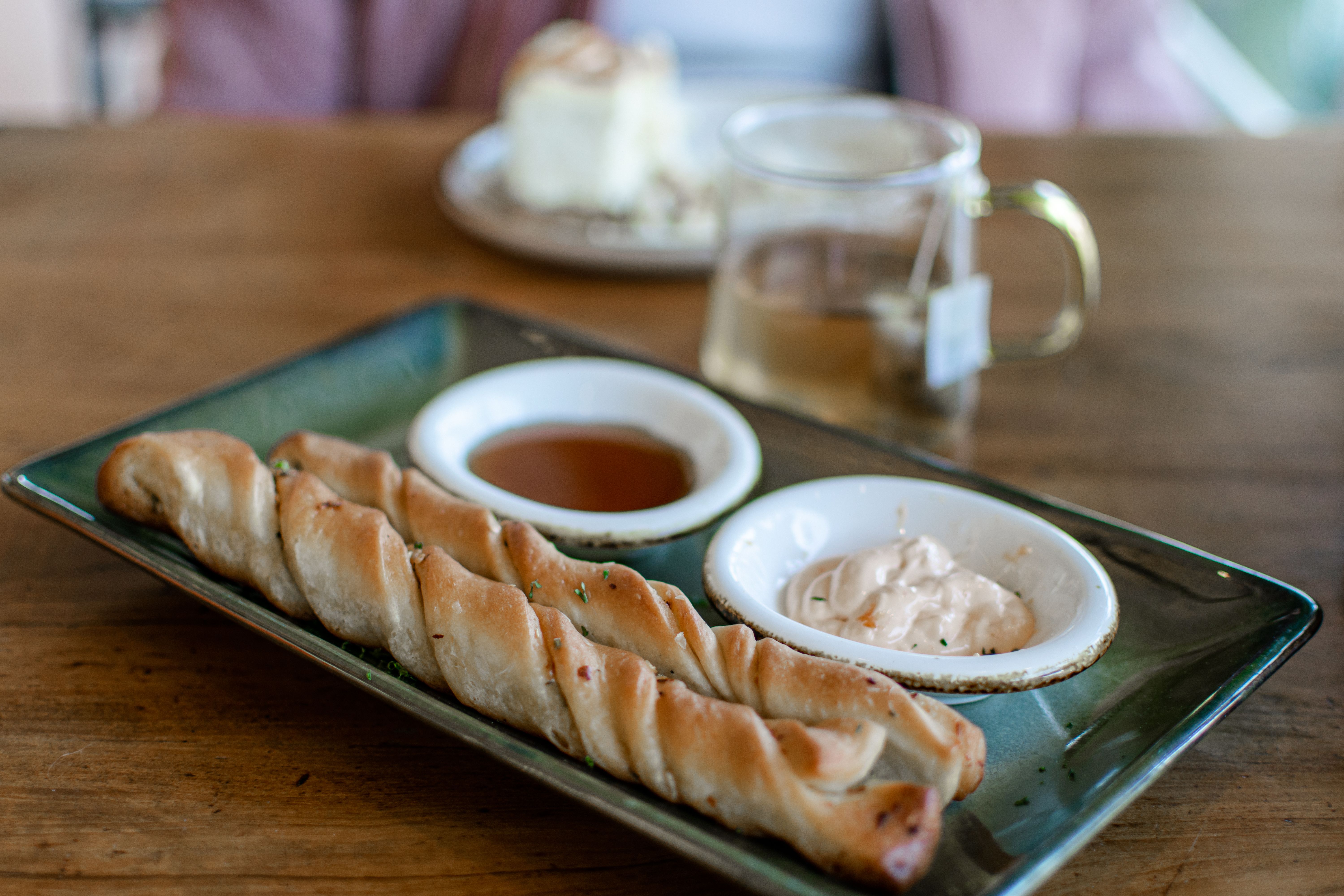 Appetizing breadsticks with sauces arranged on a plate for a cozy dining experience.