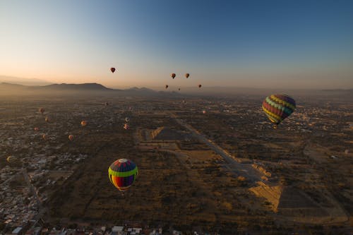 Aerial View of Beautiful Landscape with Hot Air Balloons Soaring in the Sky