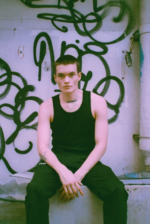 Man Wearing a Black Tank Top and Pants 