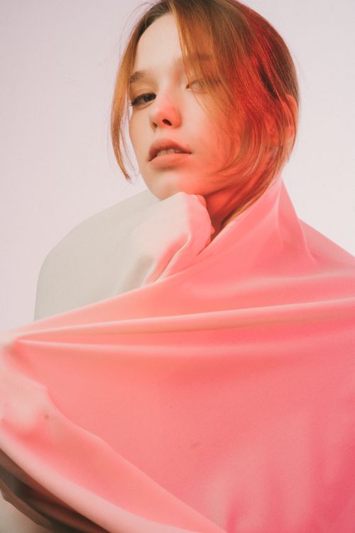 Free Creative studio portrait of a woman with fabric and neutral expression. Stock Photo