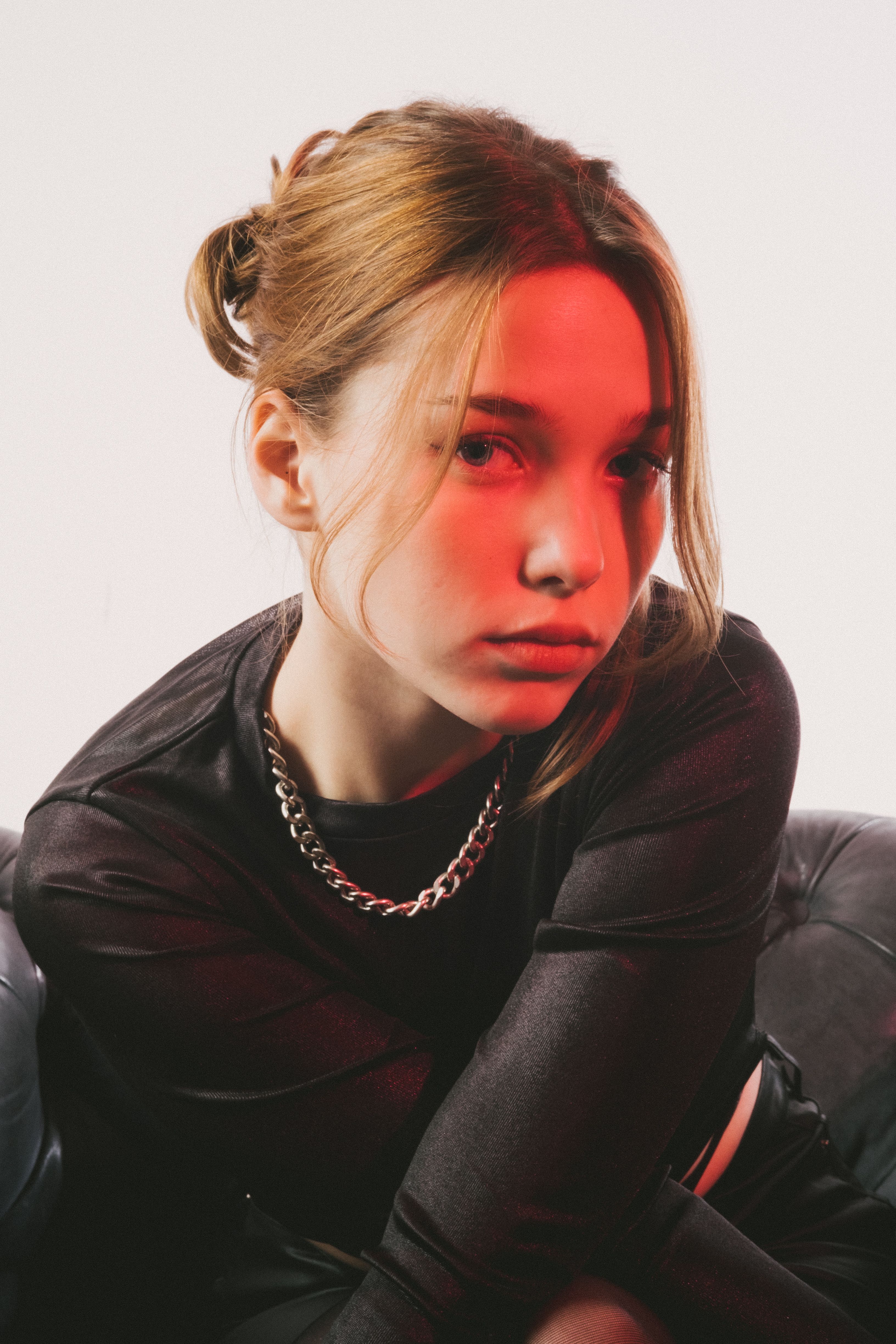 A captivating portrait of a woman with red lighting and modern styling.