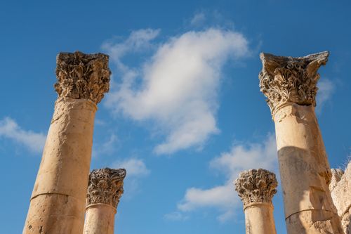 Free Explore the historic Roman columns of Jerash, Jordan beneath a clear blue sky. Stock Photo