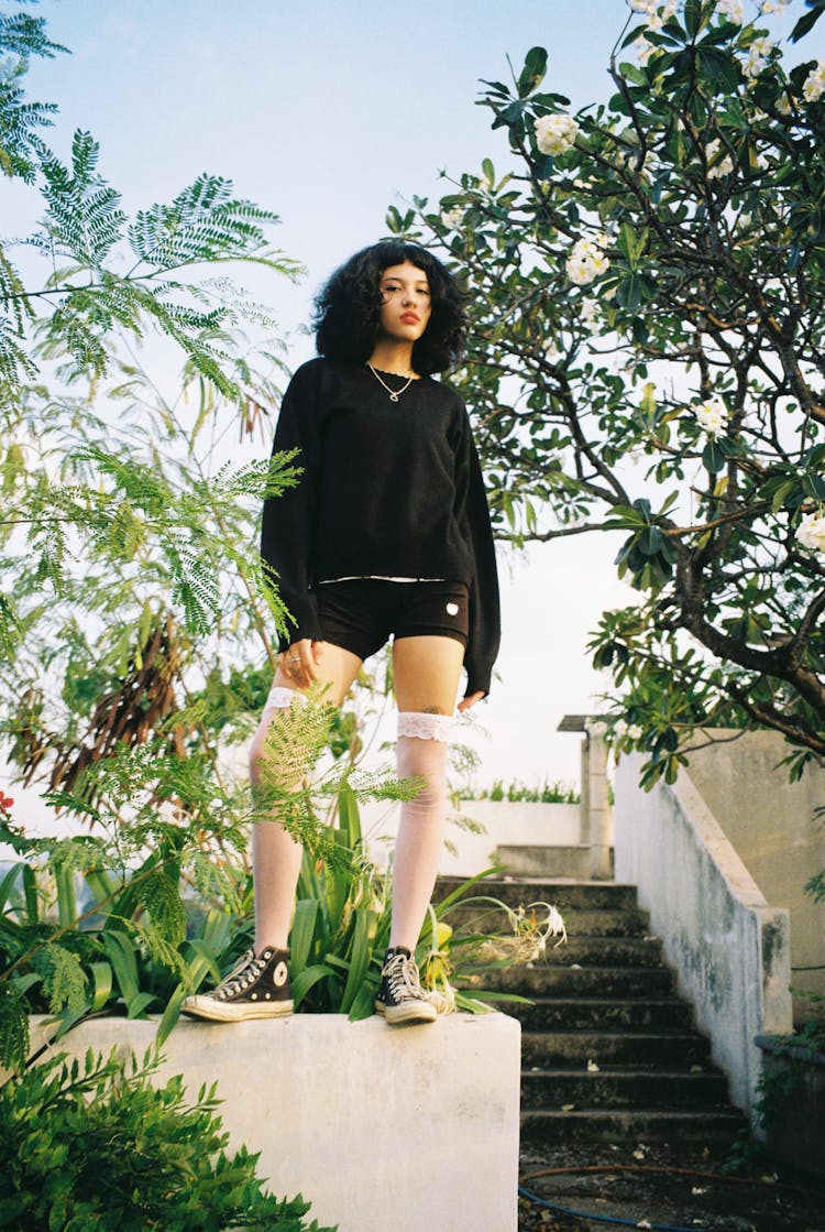 Photo Of A Woman Standing On The Wall And Wearing White Stockings