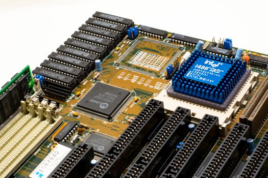 Close-up of vintage Intel 486DX2 CPU on a classic motherboard with electronic components.