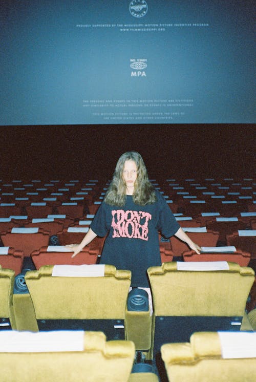 A Woman Stading in a Movie Theater
