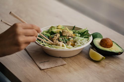 Free Vegetable Salad With Avocado and Lime in White Bowl Stock Photo