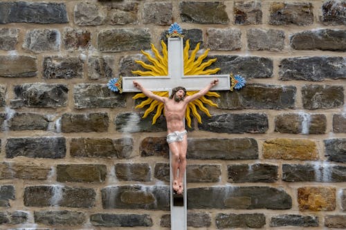 A Crucifix Hanging on Brick Wall