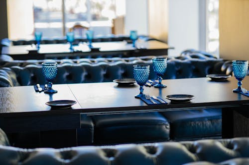 Classic interior of dining hall with served glasses in restaurant