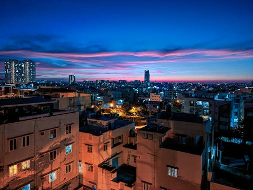 Aerial View of Illuminated Buildings in City at Sunset 