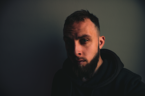 Free Intense moody portrait of a bearded man in a hoodie, captured in Yerevan, Armenia. Stock Photo