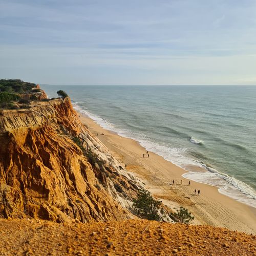 Free Explore the golden cliffs and serene beaches of Albufeira's Algarve coastline in summer. Stock Photo