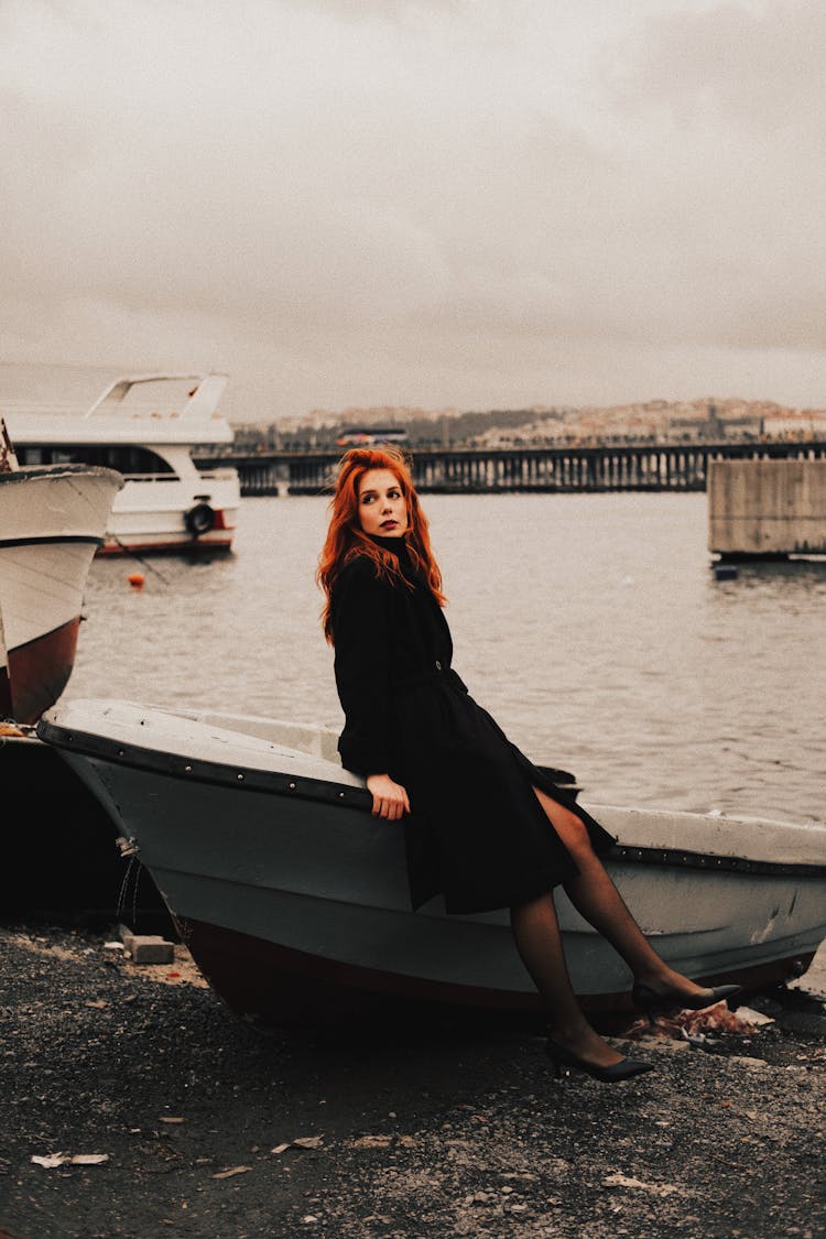 Woman Posing By Boat Near Water In City