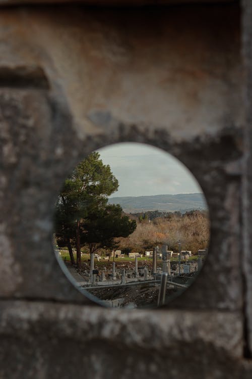 A mirror reflecting a view of a cemetery