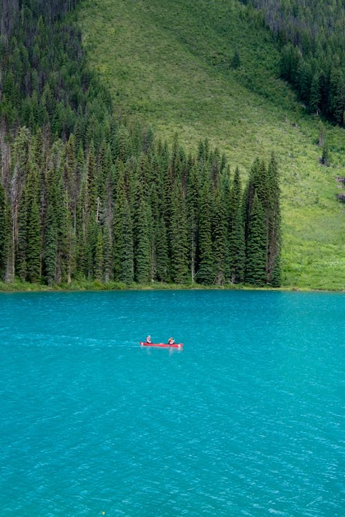 People Riding a Canoe in the Lake