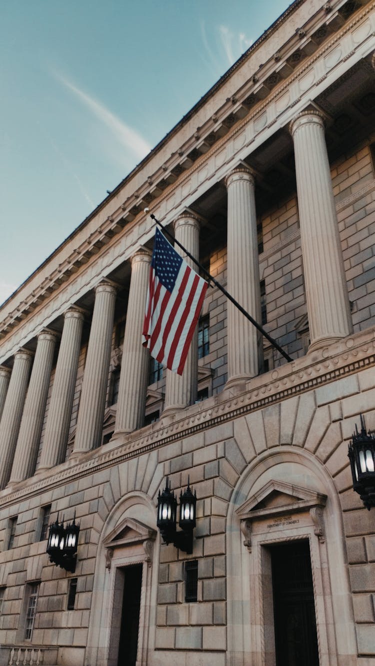 US Flag On The Façade Of The Department Of Commerce In Washington DC, United States Of America